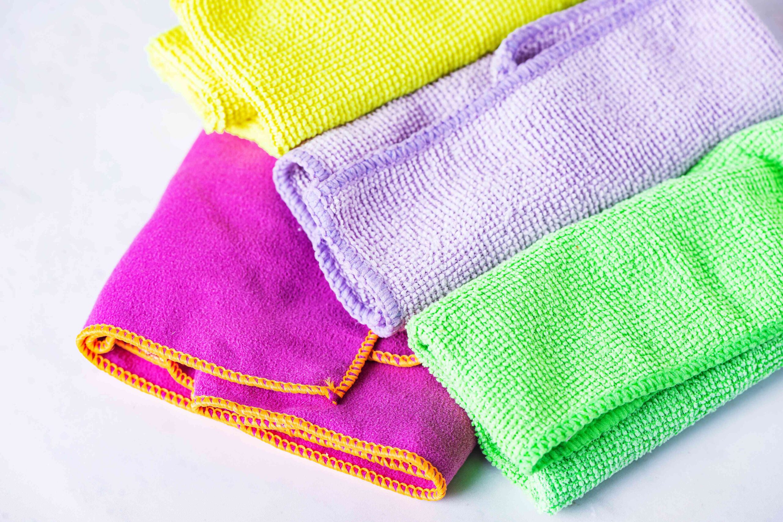 White cotton cloth or microfiber cloth blotting a liquid spill on carpet to prevent stains