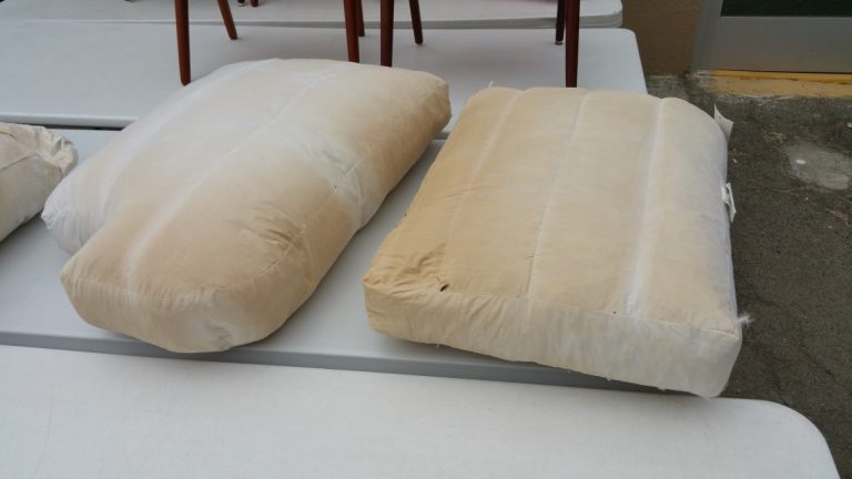 Close-up of luxury down cushion upholstery showing potential discoloration from flame retardant treatment