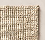 Close-up of a jute rug showing natural fiber texture and weave