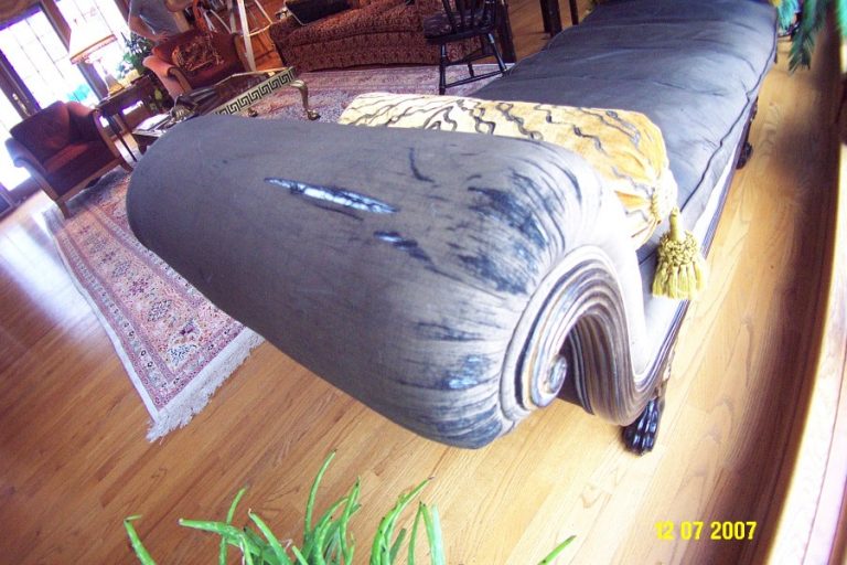 Sunlight shining on a silk upholstered chair near a window in a waterfront home