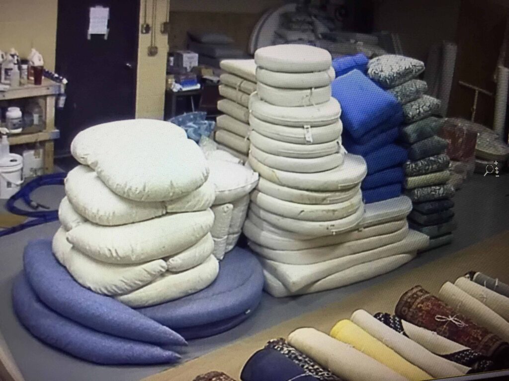 Outdoor cushions awaiting professional cleaning at Alec’s Carpet & Upholstery Cleaning LLC plant.