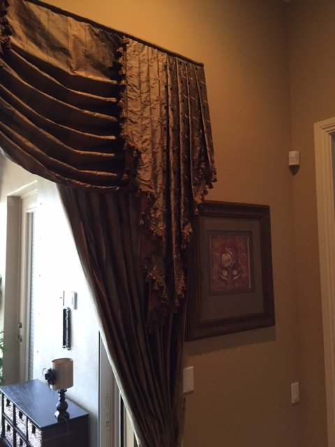 Alec of Alec’s Carpet & Upholstery Cleaning professionally cleaning window treatments in your home