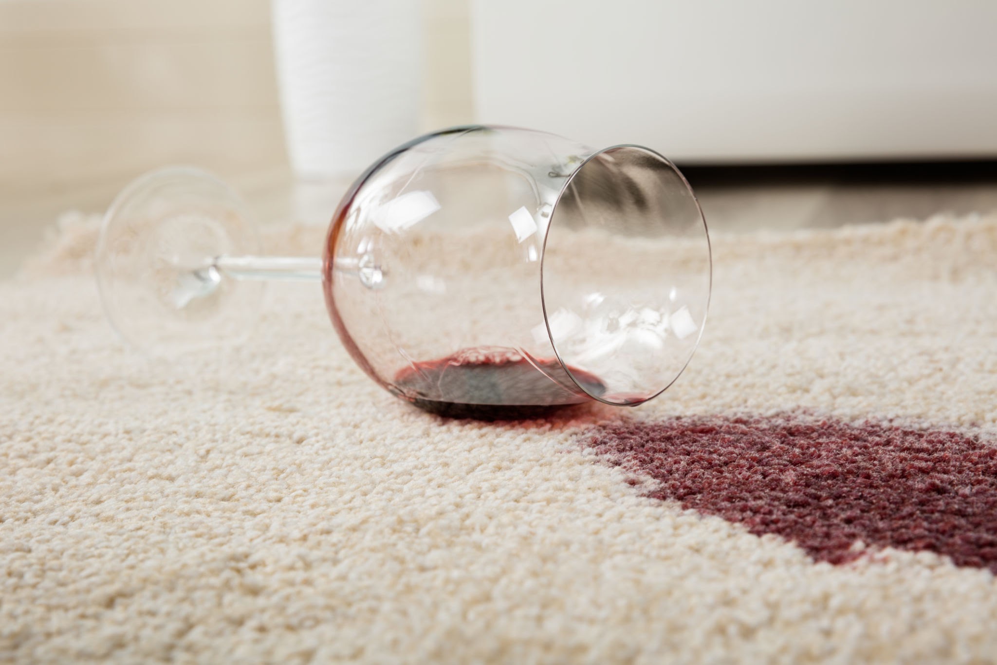 Red wine spilled on a light-colored carpet or sofa fabric