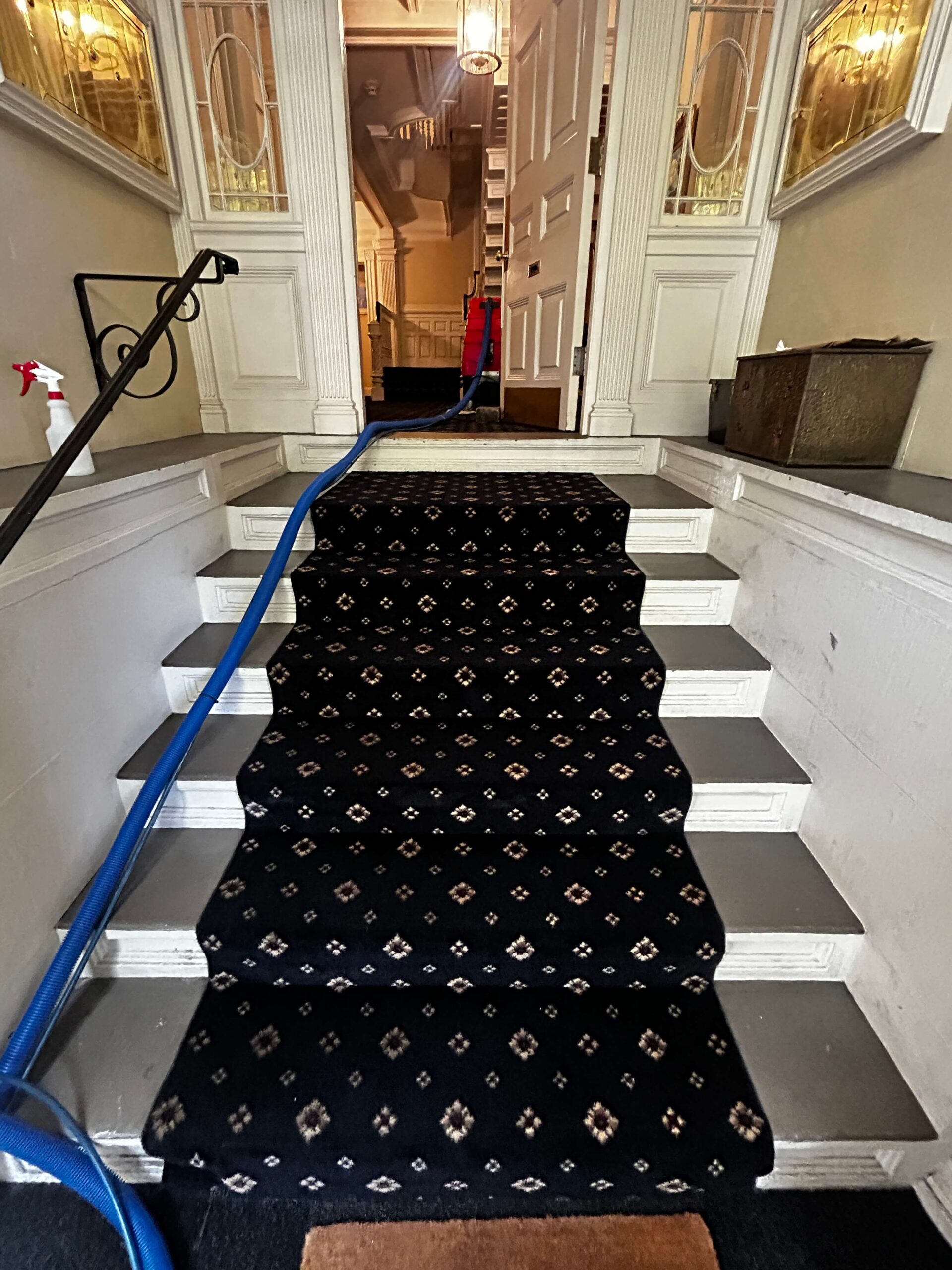 Professional carpet cleaning service on a residential staircase in Boston, Massachusetts, showing deep soil removal and groomed fibers