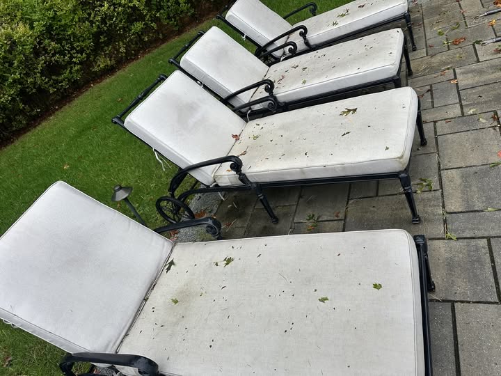 Outdoor furniture cushions before professional cleaning.